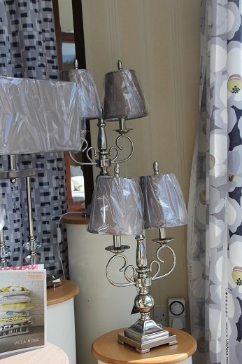 Fabric panels hanging in front of a showroom window so the light comes through the weave