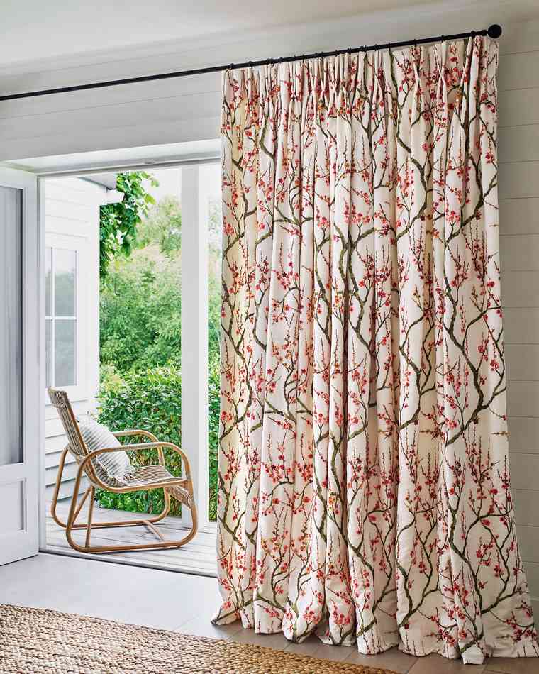 Floral curtains hung either side of a set of french doors