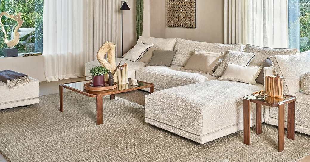 A neutral living room scheme with curtains, cushions and a rug picked to match