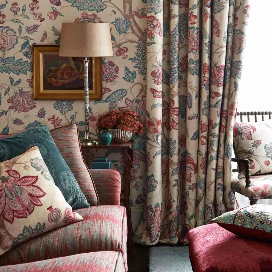 Patterned wallpaper and matching curtains in a sitting room